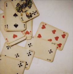 four playing cards are laying on top of each other