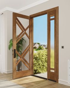 an open wooden door in a white room with wood flooring and large windows looking out onto the countryside