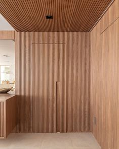 an empty bathroom with wooden walls and flooring