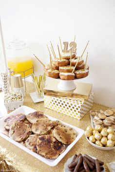 a table topped with lots of food and desserts