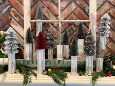 christmas decorations are displayed in front of a window