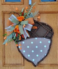 a door hanger decorated with orange and blue flowers