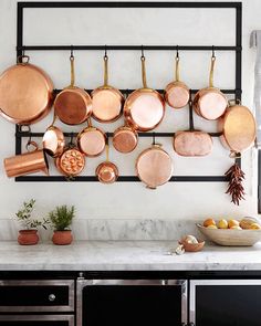 pots and pans are hanging on the wall