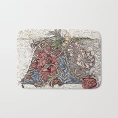 a bath mat with flowers and leaves on it