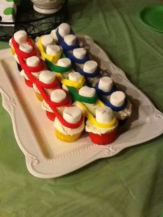 there are cupcakes with marshmallows on them sitting on a tray