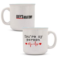 two white coffee mugs with the words grey's anatomy and you're my person on them