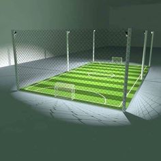 a soccer field in the middle of a room with lights shining on it's sides