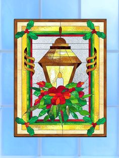 a stained glass window with a lantern and poinsettis