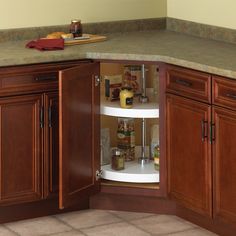 an open cabinet in the corner of a kitchen