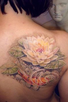 the back of a woman's stomach with an image of a flower on it