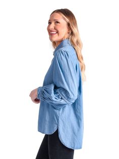 The classic Oxford shirt is our essential piece for our Core Collection. Our fun and edgy twist on a classic button-up style features a pleated balloon sleeve detail and signature gold buttons. Cotton fabric in Denim Chambray. All Emily McCarthy Clothing pieces feature a signature "Invite Joy" tag to encourage inviting joy into your life while dressing for all of life's occasions. Details: 51% Cotton 49% Spandex Slightly Tailored Fit Classic Fit with sleeve detail Fit: True to Size with slight s Everyday Relaxed Fit Tops With Balloon Sleeves, Trendy Balloon Sleeve Blouse In Relaxed Fit, Trendy Blouse With Balloon Sleeves And Relaxed Fit, Everyday Balloon Sleeve Tops Relaxed Fit, Trendy Balloon Sleeve Blouse With Relaxed Fit, Classic Medium Wash Tops For Casual Gatherings, Classic Blue Top For Casual Gatherings, Classic Tops For Casual Gatherings, Everyday Button-up Tencel Tops