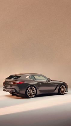 the bmw concept car is shown in front of a beige background with light coming from behind it