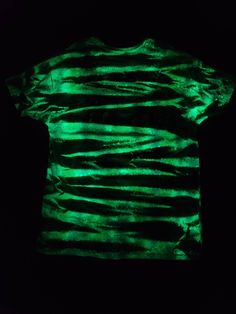 a t - shirt that is glowing green in the dark