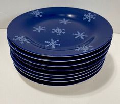 a stack of blue plates with snowflakes on them