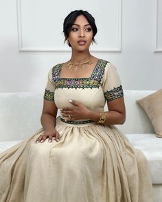 Experience the timeless beauty of this modern Ethiopian Habesha dress, crafted from gorgeous cream-colored fabric. Its intricate tile design and delicate embroidery create a captivating and sophisticated look. Perfect for special occasions or as a statement piece, this dress is a celebration of Ethiopian artistry and will turn heads wherever you go. Material Cotton Thread Estimated delivery : 2 weeks to 3 weeks Contact WhatsApp +1(304)-306-2784Email: contact@ethiopian.store Modern Ethiopian Dress, Queen Sheba Ethiopian, Ethiopian Outfits, Habesha Wedding Dress, Modern Habesha Dress, Habesha Clothes, Ethiopian Dresses, Ethiopian Wedding Dress, Ethiopian Clothing