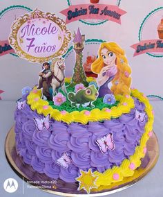 there is a purple cake with princesses on it