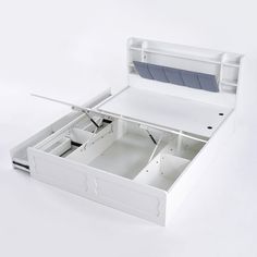 an open white box with two drawers on the bottom and one drawer in the middle