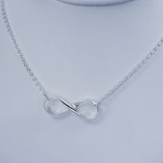 "Elegant sterling silver infinity necklace! The silver infinity symbol was hand forged from a heavy half round wire and polished to a high shine. The infinity symbol hangs from a nice medium weight rolo chain. All jump rings are soldered closed. Perfect gift to show your everlasting love for that special someone! Material: 925 sterling silver Infinity Pendant Measurement: 1\" long Necklace Length: 18 inches with a EZ handle spring clasp * Please read my shop policies for shipping and additional Modern Infinity Necklace As Gift, Modern Twist Infinity Necklaces As Gifts, Modern Twist Infinity Necklace For Gift, Modern Twist Infinity Necklace As Gift, Modern Twist Infinity Necklace For Gifts, Adjustable Sterling Silver Infinity Necklace, Silver Infinity Jewelry, Infinity Symbol Jewelry, Silver Infinity Necklace