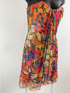 "Fun colorful light and airy Oscar de la Renta vintage 80s abstract floral silk chiffon print cocktail dress. Layers of sheer chiffon. Top layer in the floral print has a tight side flowy pleat over layer. Lined in two layers of sheer coral silk chiffon. Boned and lined bustier with left side zipper that is covered with hidden tiny snap buttons. Empire under bust grosgrain tape that secures at left side. All these exquisite details are for support and show true craftsmanship. Marked size 4 - see Vintage Silk Chiffon Summer Dress, Vintage Silk Chiffon Dress For Summer, Multicolor Silk Chiffon Dress For Spring, Retro Sheer Summer Dress, Dress Layers, Sarong Dress, Strapless Bustier, Garment Industry, Sheer Chiffon