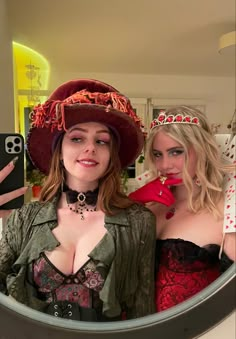 two women dressed in costumes taking a selfie