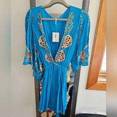 Brand New With Tag Free People Turquoise Dress Size Medium Bohemian V-neck Dress With Multicolor Embroidery, Blue Free People Dress, Embroidered Dress Boho Free People, Multicolor Boho Print V-neck Mini Dress, Multicolor Turquoise Pendant Necklace, Spiritual Style, Turquoise Dress, Free People, Brand New, Mini Dress