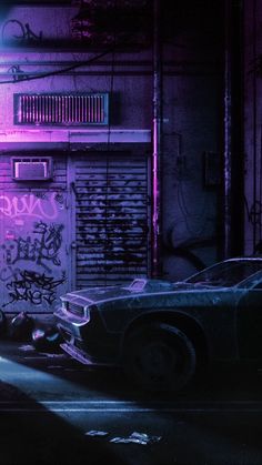 two cars parked next to each other in front of a building with graffiti on it