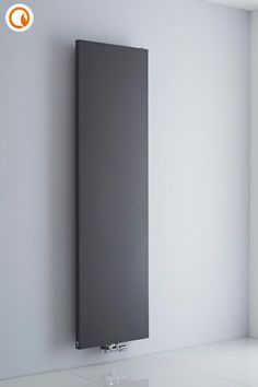 a modern radiator mounted on the wall in an empty room with white walls