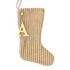 a striped christmas stocking with the letter a hanging from it's side,