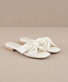 20% off at https://lithologieco.com/collections/shoes/products/kori-knot-flat-sandals-off-white Designed for a stylish minimalist, these knotted sandals are a versatile addition to any wardrobe. Heel Height: 0.75" Type of Closure: Slip On Upper Material: Vegan Leather Upper Insole Material: Padded Insole Hoco Shoes Flats, White Sandals Flat, White Flat Sandals, Sandal Slippers, Random Products, Greece Trip, Beach Wedding Shoes, Womens Sandals Summer, Wedding 2024