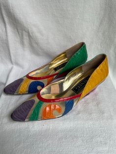 We are so in love with these shoes!  They scream 1980s early 1990s fashion.  Multi Color Snakeskin Leather with a closed toe and sheer sectioned design.  Overall condition is very good, with the exception of a repair needed on the left foot heel.  The black heel has come off and needs to be replaced.   This will be a minor repair at a shoe shop.  These heels were acquired from a large estate in South Charlotte.  While I would rate these very good vintage condition, the buyer is the final judge. Spring Retro Heels With Pointed Toe, Retro Pointed Toe Heels For Summer, Vintage Pointed Toe Heels In Synthetic Material, Vintage Synthetic Pointed Toe Heels, Vintage Synthetic Heels With Round Toe, Vintage Synthetic Round Toe Heels, Retro Wedge Heels For Party, Vintage Synthetic Closed Toe Heels, Vintage Synthetic Heels For Summer