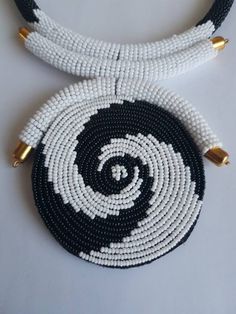 "This necklace is 100% handcrafted using white and black beads. Measurements: 18 inches around the neck. Pendant: 4\" Perfect for weddings, African themed events, traditional events etc. **Buy multiple items and pay shipping for 1 item only.The rest ships free. More neckleces here; https://www.etsy.com/shop/TribalTess?ref=seller-platform-mcnav&section_id=21306083 Back to my shop; https://www.etsy.com/shop/TribalTess?ref=seller-platform-mcnav" Unique White Jewelry With Black Beads, White Beaded Necklaces With Black Beads As Gift, White Beaded Necklaces With Black Beads For Gifts, White Beaded Necklaces With Large Beads, Handmade White Beaded Round Necklace, White Beaded Necklace With Large Beads, White Beaded Necklace With Large Round Beads, White Necklaces With Black Beads, Neck Pendant