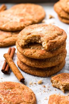 cinnamon spice cookies stacked on top of each other with cinnamon sticks in the foreground