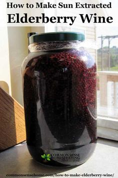 a jar filled with elderberry wine sitting on top of a window sill