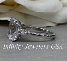 an image of a diamond ring with the words infinity jewelers usa on it