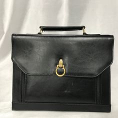 Very beautiful rigid briefcase bag for men and women. In very good condition, except for a little wear to the bottom corners of the bag. Measures 13 inches (33cm) wide. X 10 inches (25 cm) high X 1.5 inches (4 cm) thickness. This bag has three divisions, the center one of which closes with a zipper. A small storage compartment with zipper. At the front, this bag opens with two zippers to store business cards, key rings, small storage closed with a snap button. Terms of sale Any item purchased on Black Briefcase, Black Leather Messenger Bag, Black Leather Briefcase, Briefcase Bag, Black Leather Satchel, Portable Bag, Leather Laptop Bag, Leather Laptop, Business Bag