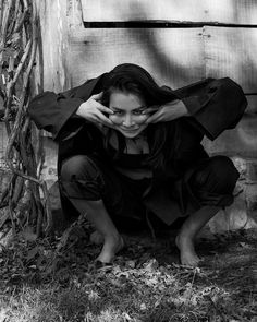 black and white photograph of a woman covering her face