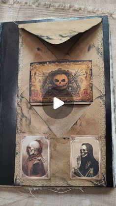 an open book with pictures on it and a skull in the middle, sitting on top of a table