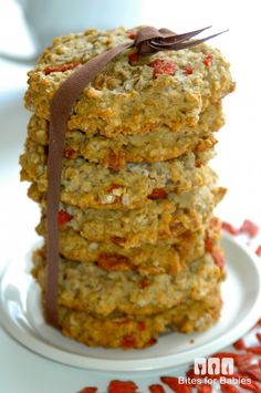 a stack of cookies on a plate with a brown ribbon