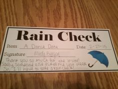 a rain check card with an umbrella on the front and back side, sitting on a wooden table