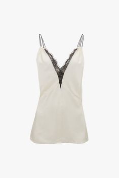 The iconic 1990s cami top is given fresh relevance in the Lace Detail Cami Top. Exquisitely cut from crepe back satin and presented in romantic Ivory, it has a lace-trimmed, deep-V neckline and a pleat beneath the bust. Double rouleau straps add a sensuous finishing touch, while a contrasting black topstitch adds a refined talking point. Styled with the Deconstructed Skirt Victoria Beckham Lace Detail Cami Top In Harvest Ivory  - Size 12 UK Size 12 Uk, Cami Top, Cami Tops, Victoria Beckham, Lace Detail, Lace Trim, Size 12, Size 4, Size 10