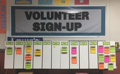 a volunteer sign - up board in front of a bulletin board