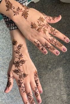 two hands with hendi tattoos on them