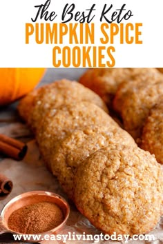 the best keto pumpkin spice cookies on a baking sheet with cinnamon sticks and spices