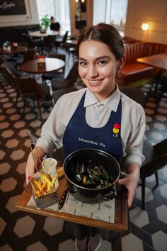 a woman holding a tray with some food on it