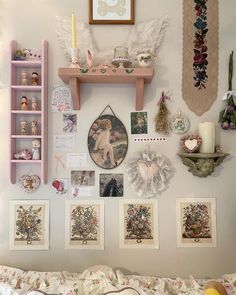 the wall is covered with pictures and other items, including an angel's wings