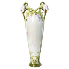 a white and green vase with flowers on it's sides, against a white background