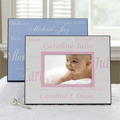 two frames with a baby's name on them sitting on top of a bed