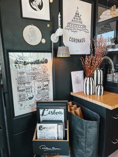 a coffee shop with black walls and pictures hanging on the wall, along with other items