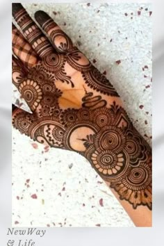 the hand is decorated with henna designs