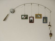 a wall with pictures hanging on it and a clock